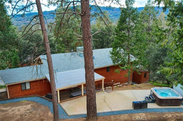 exterior space featuring a hot tub and a patio area