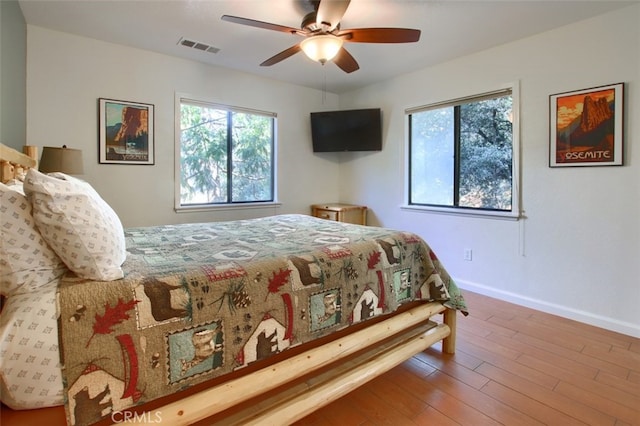 bedroom with hardwood / wood-style floors and ceiling fan