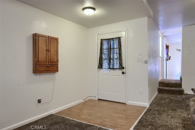 foyer entrance with light hardwood / wood-style flooring