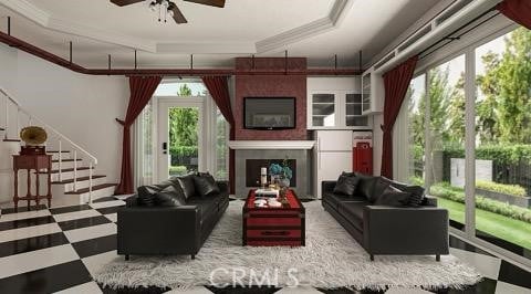 living room featuring ceiling fan, a healthy amount of sunlight, and ornamental molding