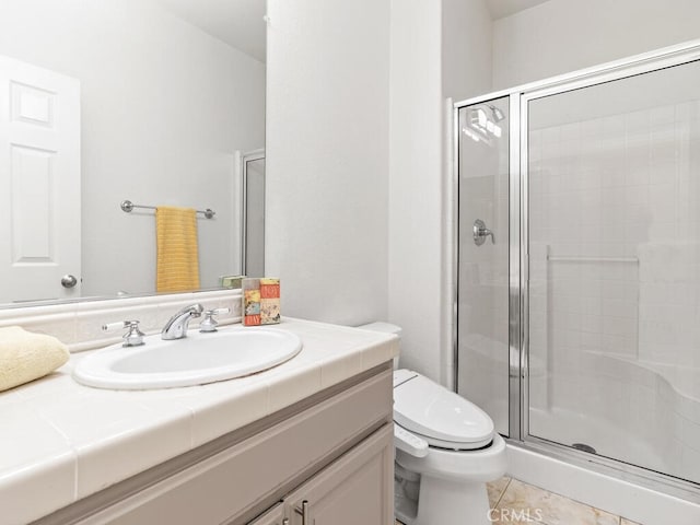 bathroom with an enclosed shower, vanity, toilet, and tile patterned floors