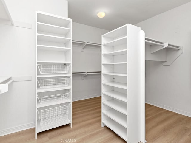 spacious closet featuring hardwood / wood-style flooring