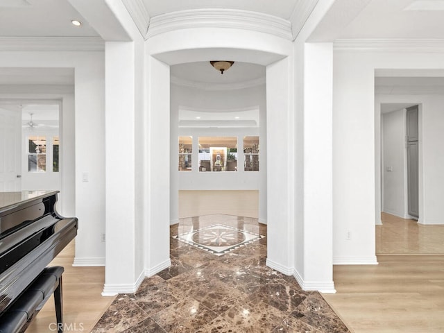 hallway featuring crown molding and light hardwood / wood-style floors