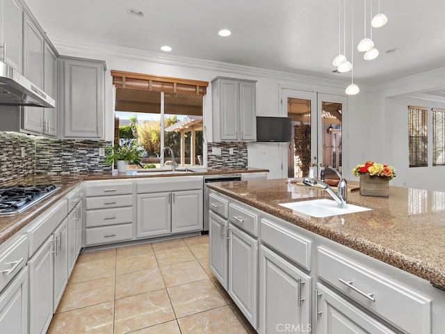 kitchen with decorative backsplash, gray cabinets, ornamental molding, and sink