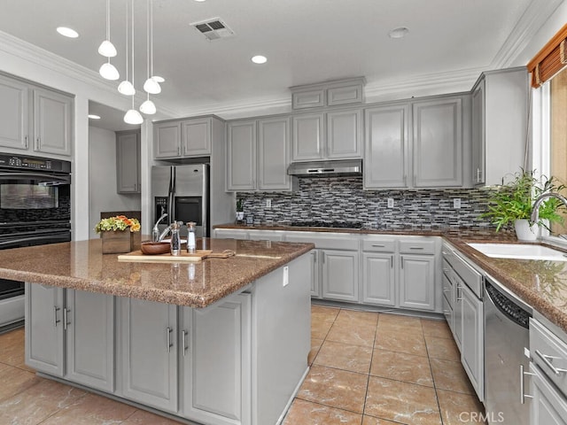 kitchen featuring sink, gray cabinets, a center island with sink, and black appliances