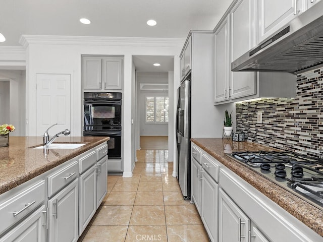 kitchen featuring backsplash, ornamental molding, stainless steel appliances, sink, and exhaust hood