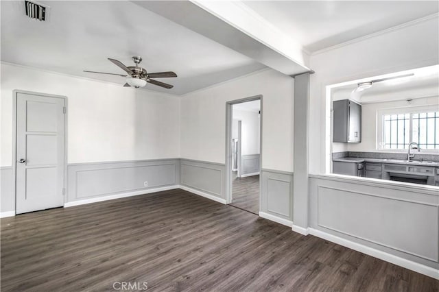 9130 S Wilton Pl, Los Angeles, CA 90047 - unfurnished living room with ornamental molding, ceiling fan, dark wood-type flooring, and wainscoting