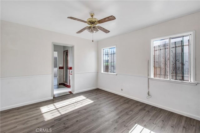 unfurnished room featuring ceiling fan and dark wood-type flooring