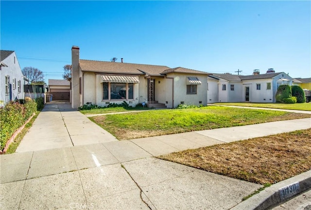 ranch-style home featuring a front yard