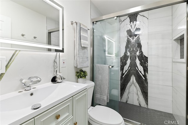 bathroom with walk in shower, vanity, and toilet