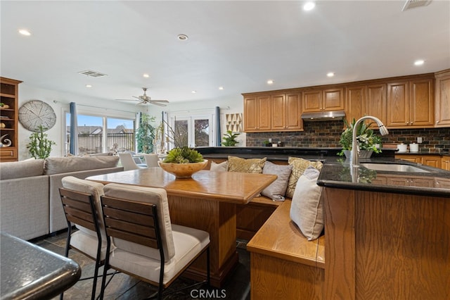 dining area with french doors, ceiling fan, and sink