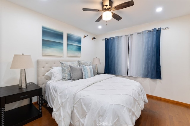 bedroom with ceiling fan and dark wood-type flooring