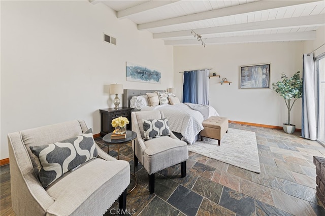 bedroom featuring vaulted ceiling with beams