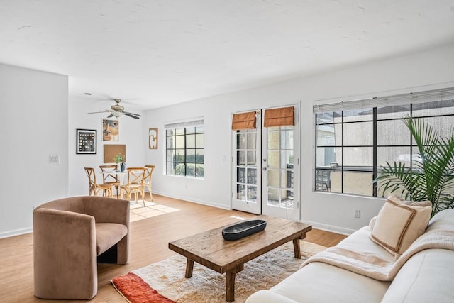 living room with ceiling fan and light hardwood / wood-style flooring