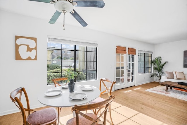 dining area with ceiling fan, a wealth of natural light, and hardwood / wood-style floors