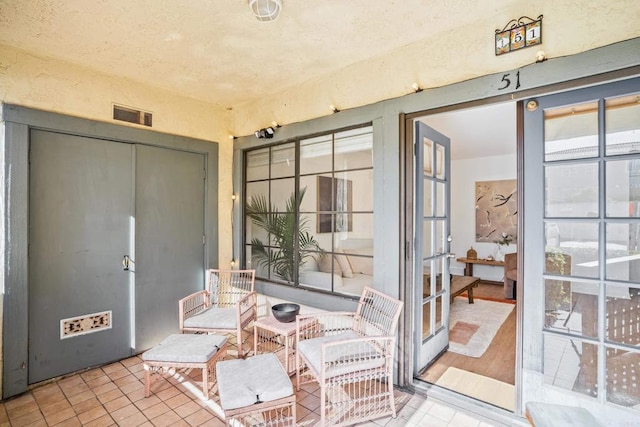 sunroom / solarium featuring french doors