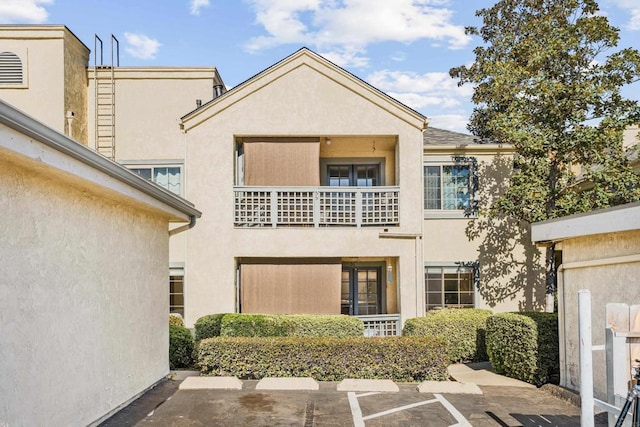 rear view of property with a balcony