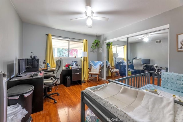 bedroom featuring ceiling fan, a closet, and hardwood / wood-style floors