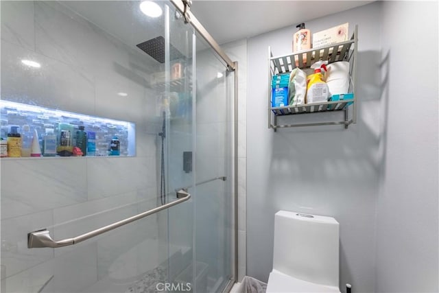 bathroom featuring toilet and walk in shower