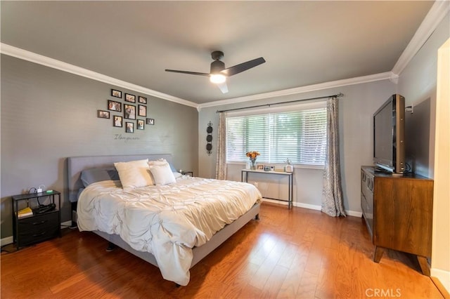 bedroom featuring ceiling fan, crown molding, and hardwood / wood-style floors