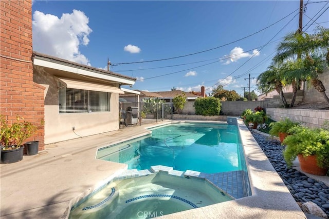 view of pool with an in ground hot tub