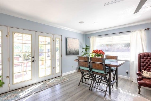 dining space with french doors, plenty of natural light, and light hardwood / wood-style floors