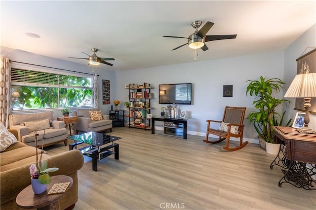 living room featuring light wood-type flooring and ceiling fan