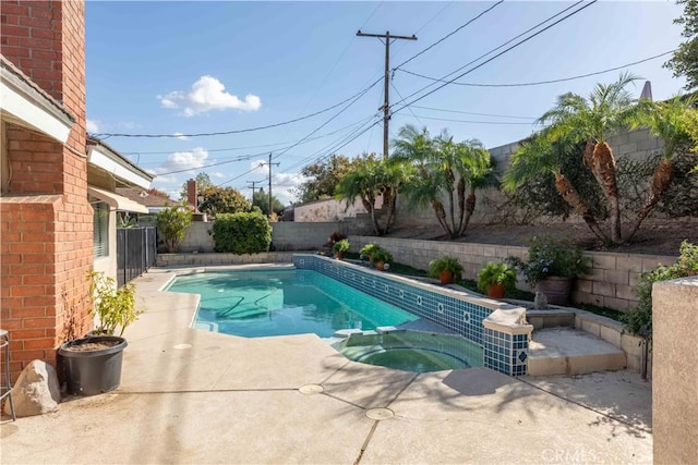 view of pool featuring a patio area and an in ground hot tub