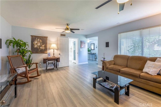 living room with light hardwood / wood-style floors and ceiling fan