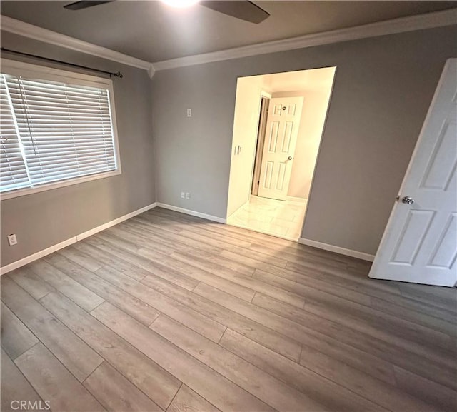 spare room featuring ceiling fan, crown molding, and light hardwood / wood-style flooring