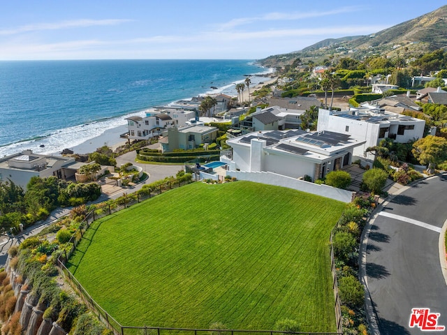 birds eye view of property with a water view and a view of the beach