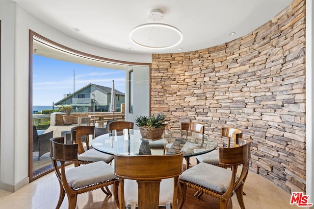 tiled dining room with a water view