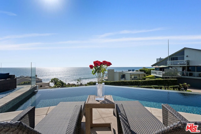 view of swimming pool featuring a water view