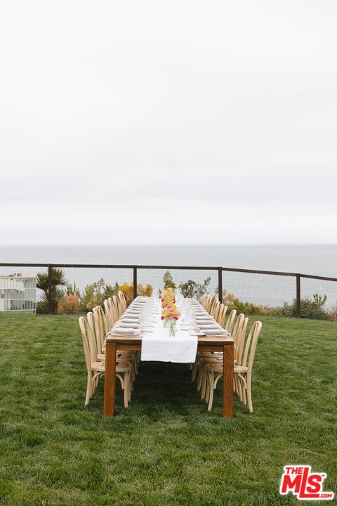 exterior space featuring a lawn and a water view