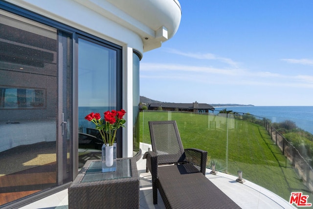 balcony featuring a water view