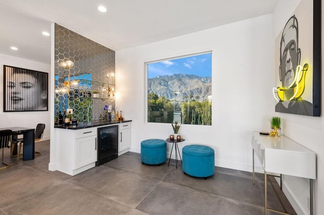 interior space featuring a mountain view, white cabinets, and beverage cooler