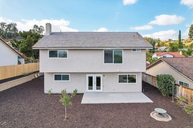 rear view of property featuring french doors and a patio