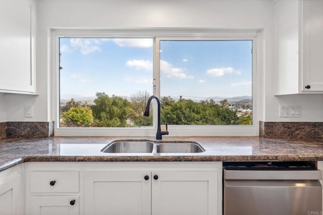 kitchen with white cabinets, dishwasher, and sink