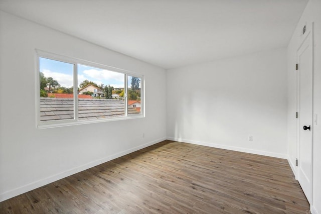 unfurnished room with dark wood-type flooring