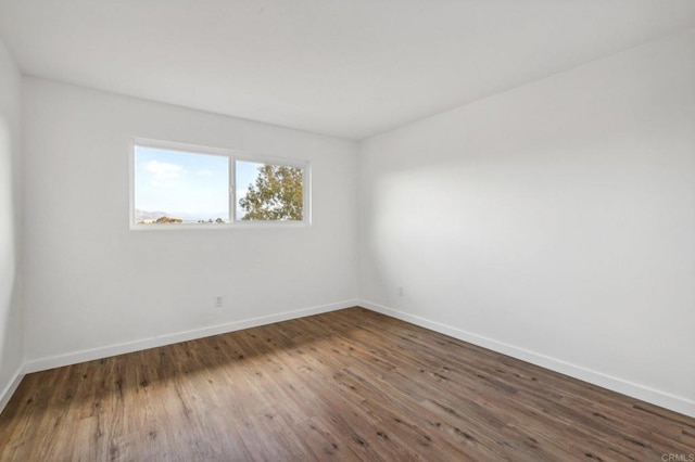 empty room featuring dark wood-type flooring