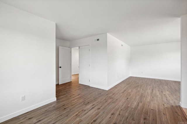 spare room featuring wood-type flooring