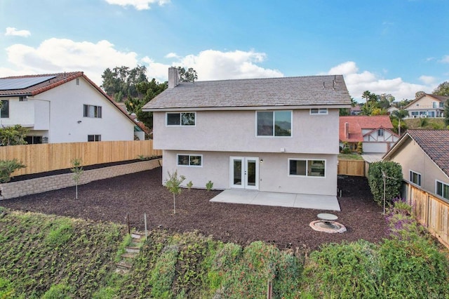 back of property featuring a patio area and french doors