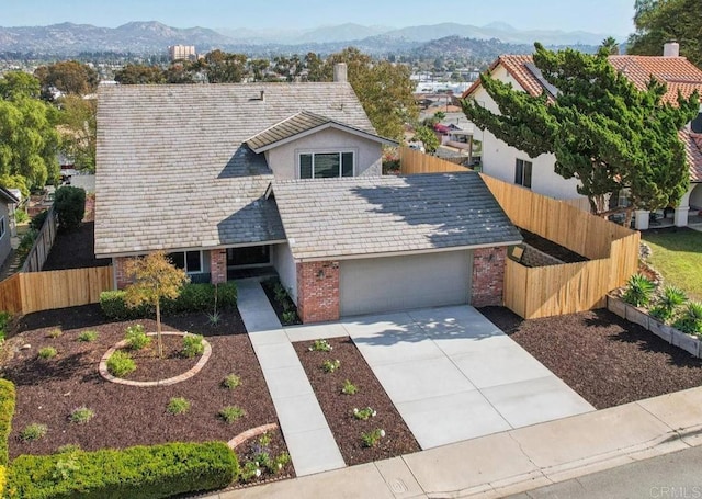 view of front of property with a mountain view and a garage