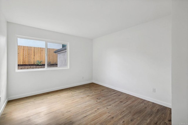 spare room with hardwood / wood-style flooring