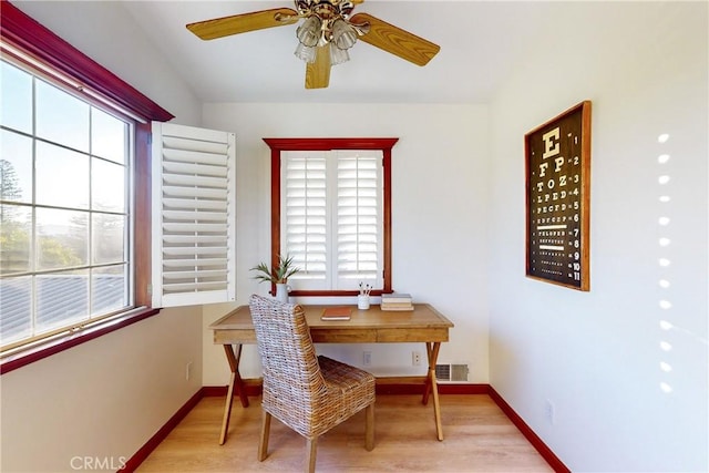 dining area with ceiling fan, a healthy amount of sunlight, and light wood-type flooring