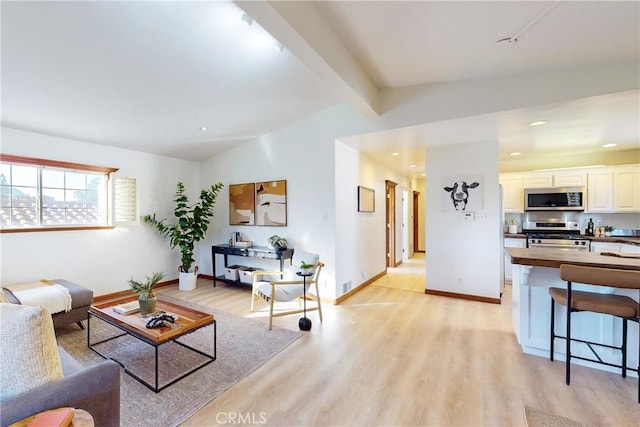 living room featuring vaulted ceiling with beams and light wood-type flooring