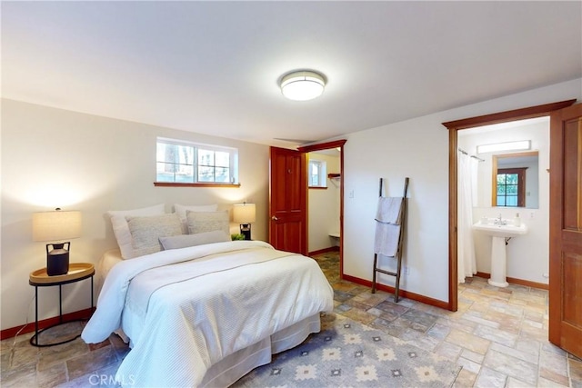 bedroom featuring sink and ensuite bath