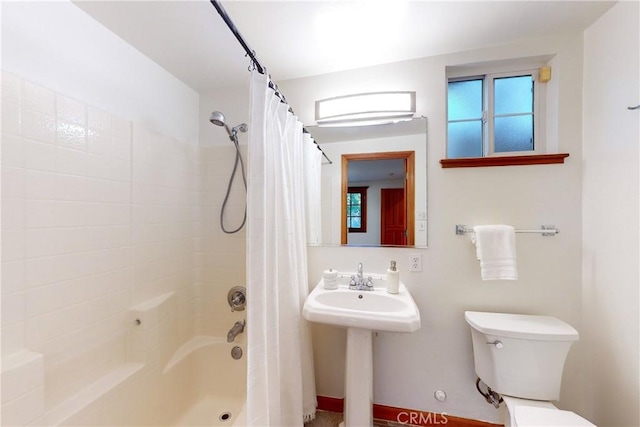 full bathroom featuring toilet, sink, and shower / bath combo with shower curtain