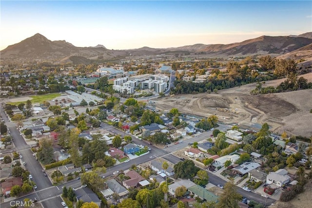 aerial view at dusk featuring a mountain view