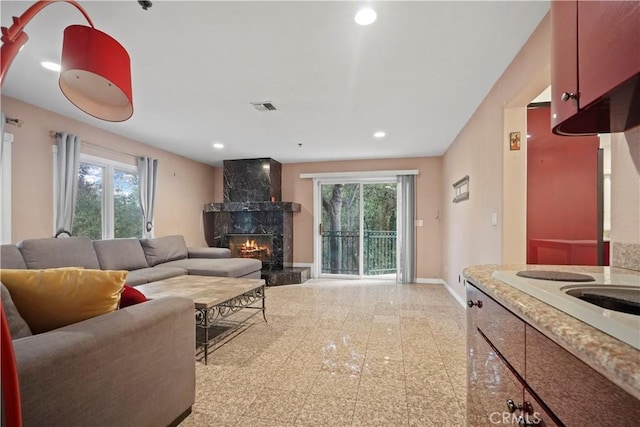 living room featuring plenty of natural light and a premium fireplace